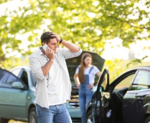 Man at car accident scene